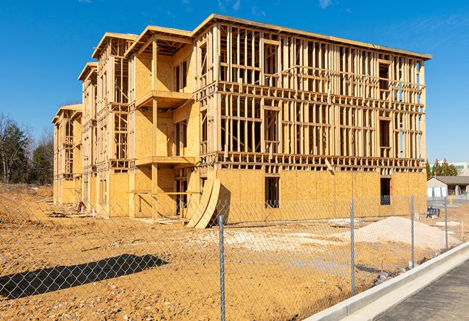 a temporary chain link fence locking away a building under renovation, serving as a security tool in Rush Springs, OK